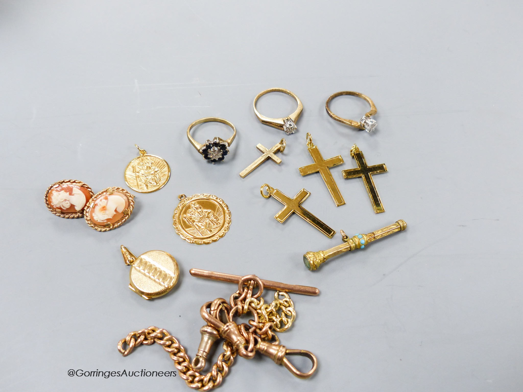 Part of a 9ct gold albert, four 9ct cross pendants, a pair of 9ct earrings, three 9ct and gem set rings, a propelling pencil and two 9ct St Christopher pendants.